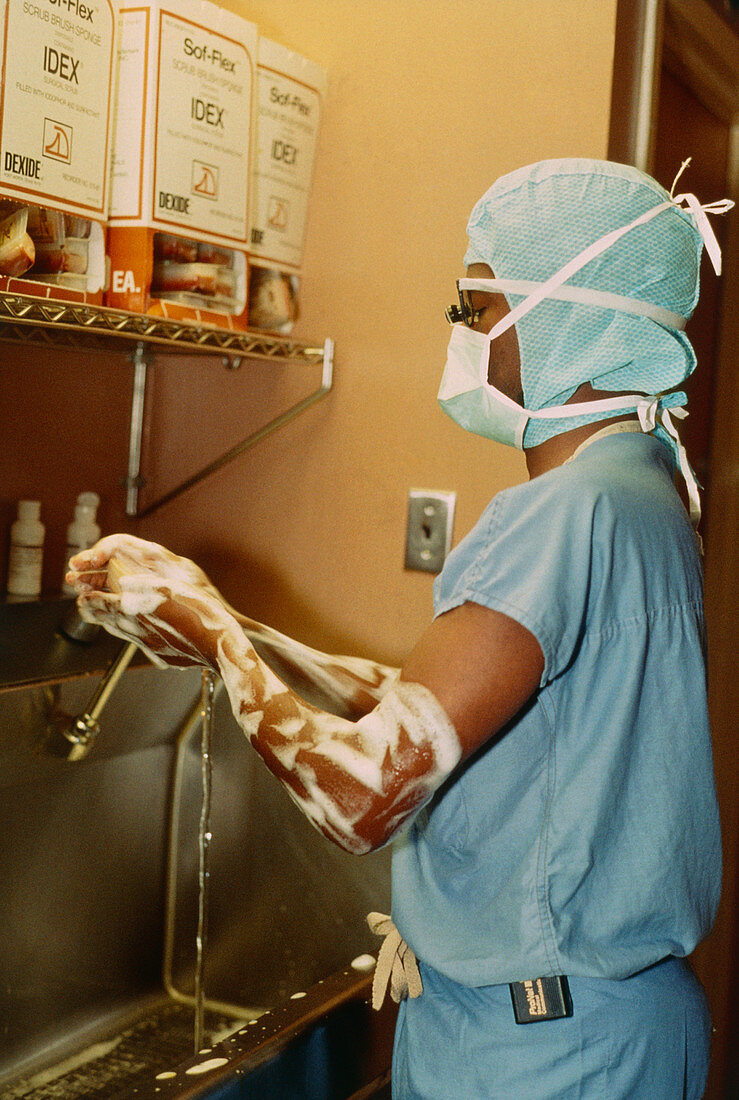 Surgeon scrubbing arms before operation