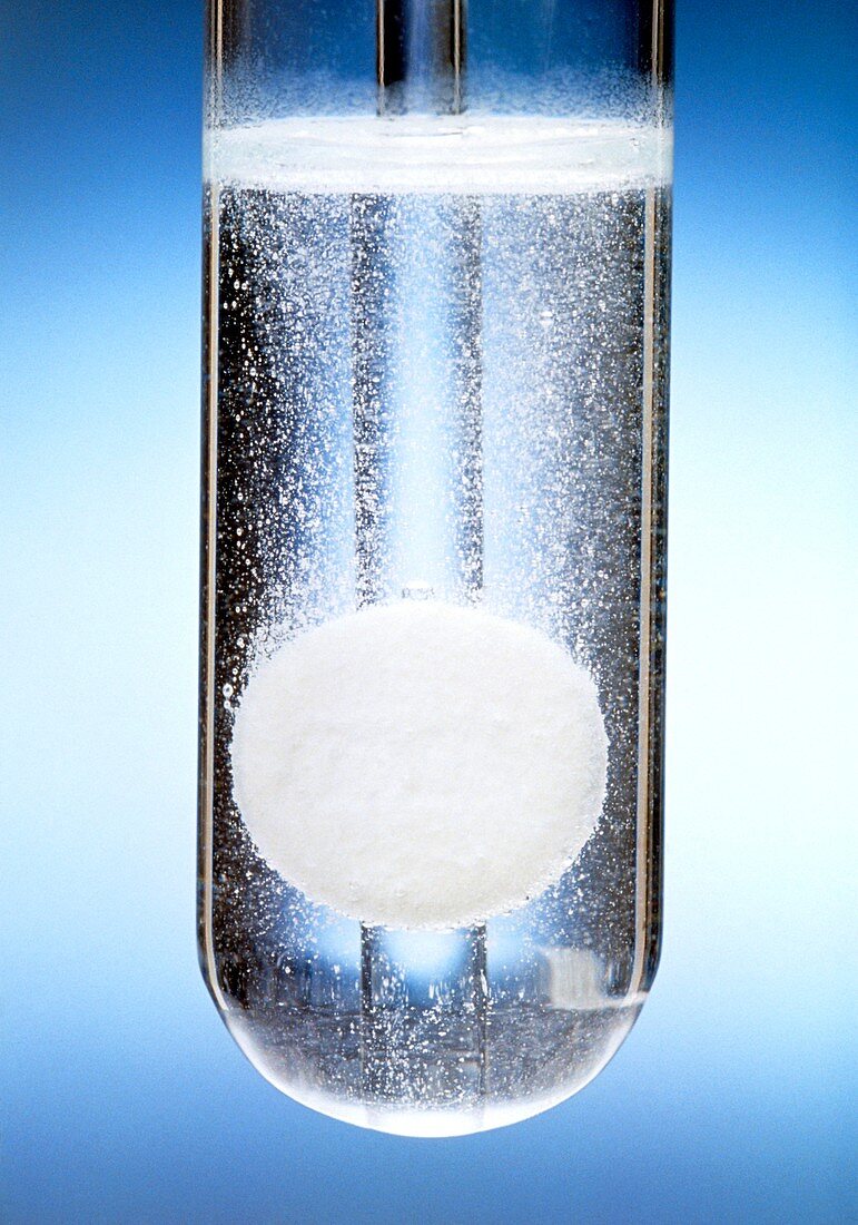 Antacid tablet dissolving in a test tube of water