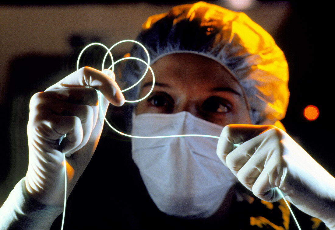 Surgeon holding a bundle of optic fibres