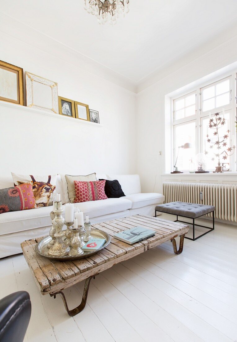 White sofa and upcycled coffee table in white living room