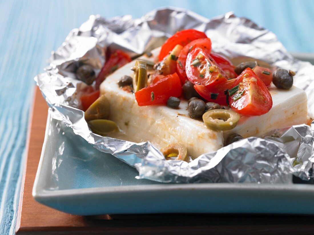 Sheep's cheese with tomatoes and olives in foil