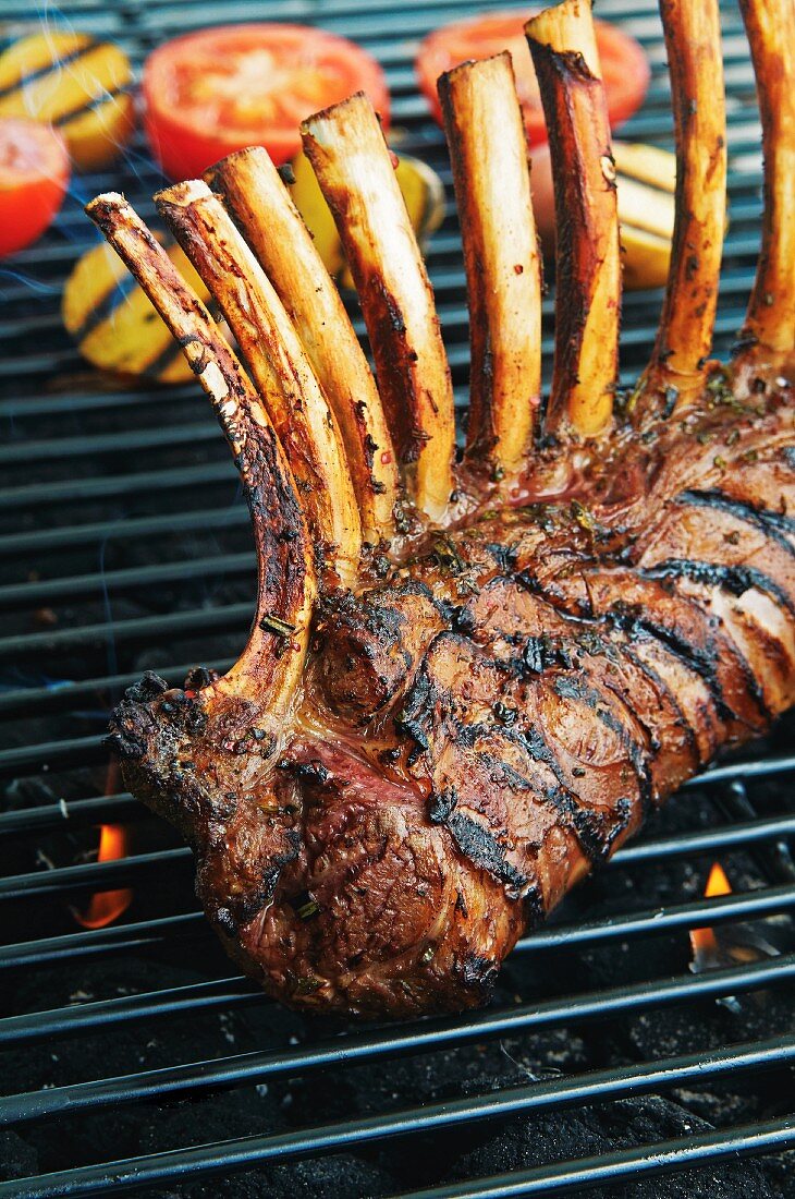 A rack of lamb with herbs and port wine on a grill rack