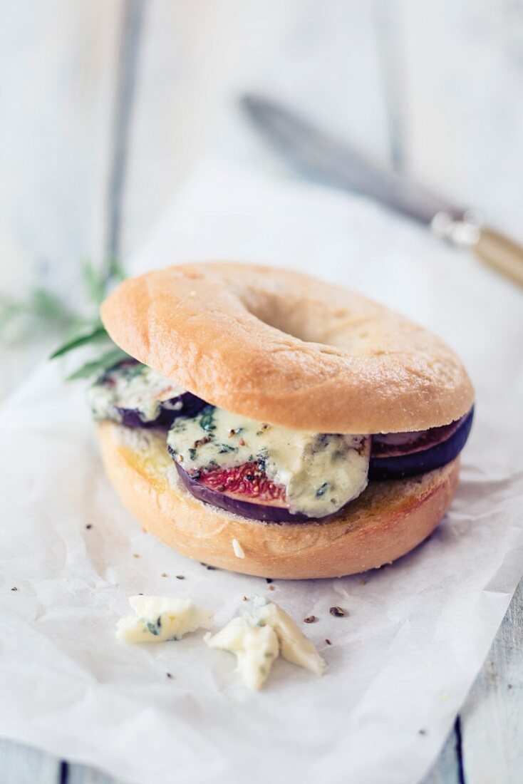 A bagel with blue cheese and figs