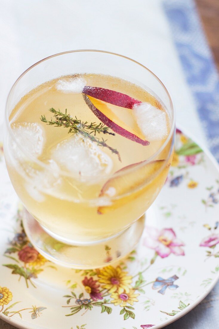 A summer cocktail with plum and thyme