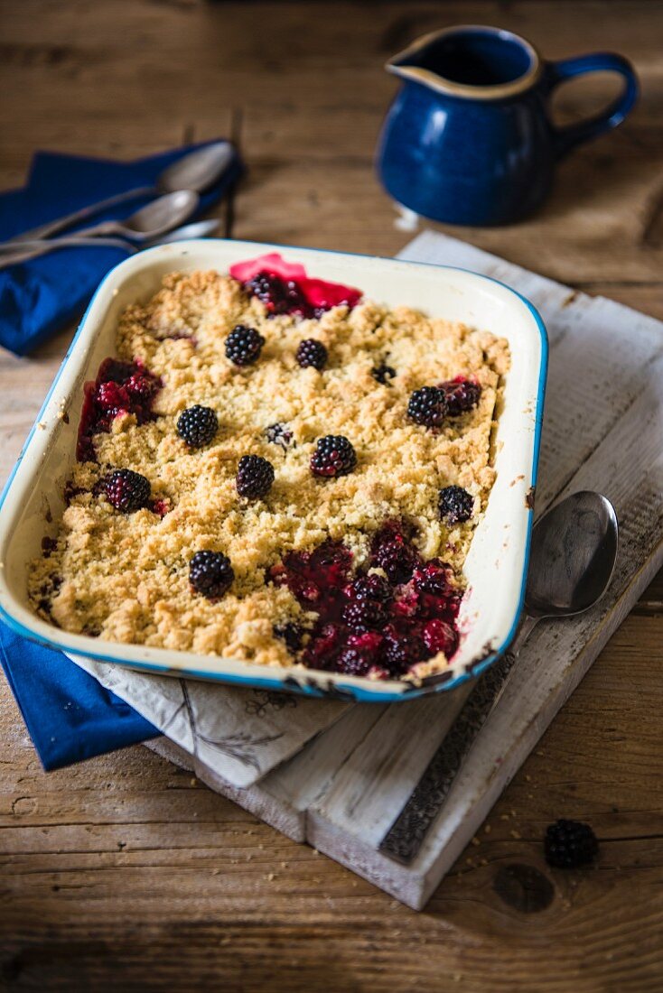 Blackberry and apple crumble in an enamel dish