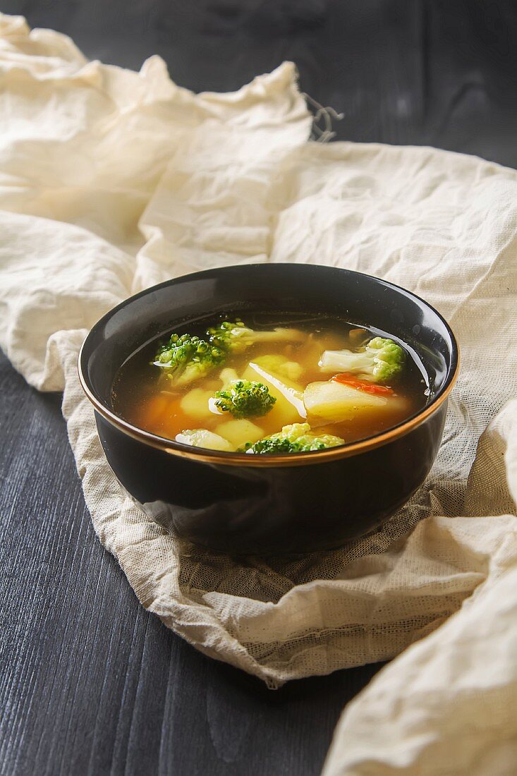 A vegetarian soup with cauliflower, broccoli and carrots