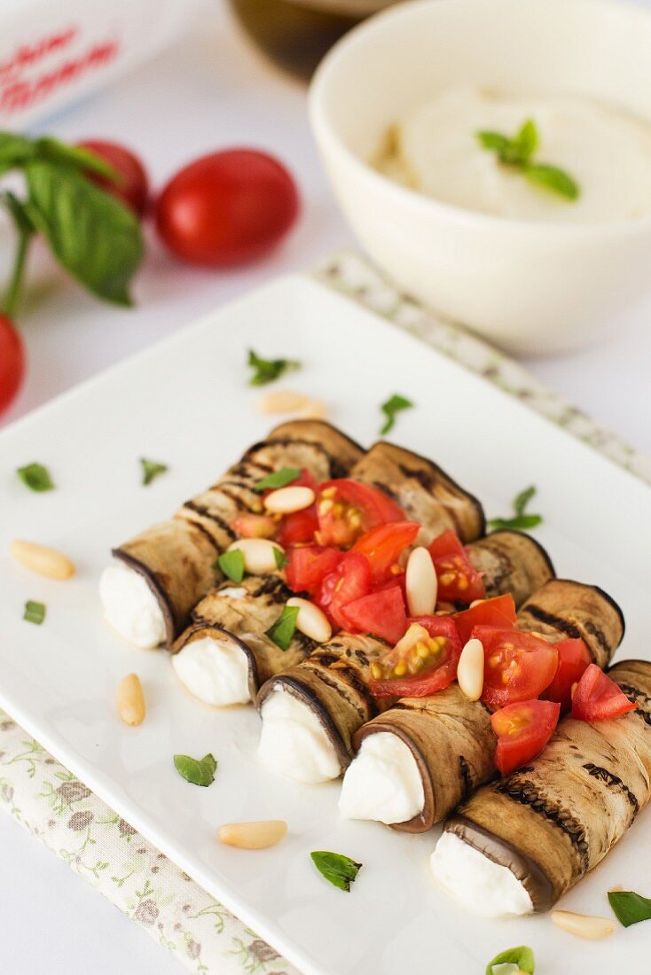 Aubergine rolls with ricotta, tomatoes and pine nuts