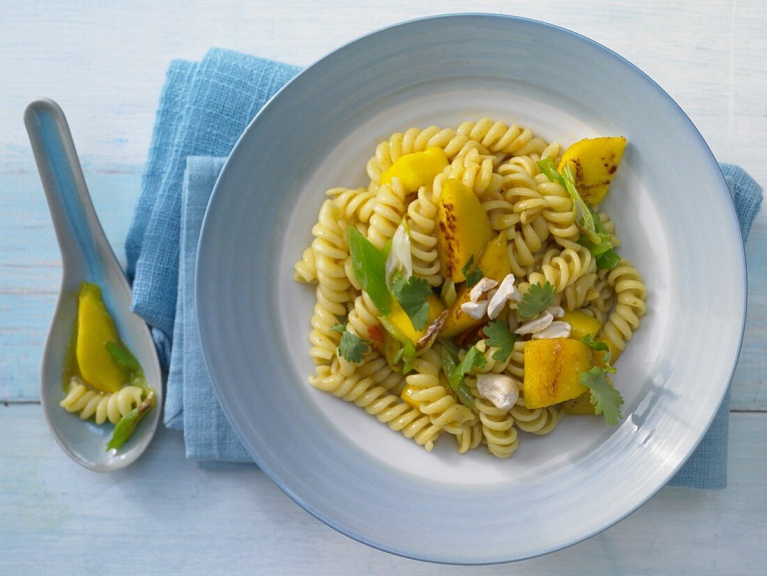 Curry and mango pasta with cashew nuts and coriander