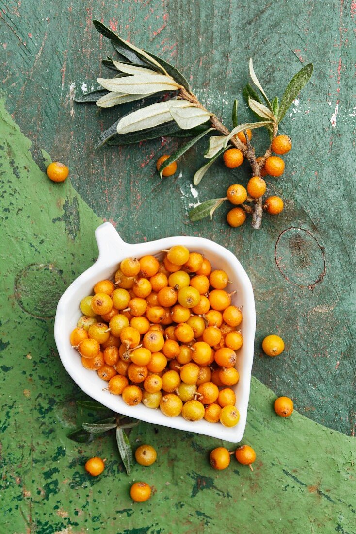 Sea buckthorn berries in a heart-shaped dish