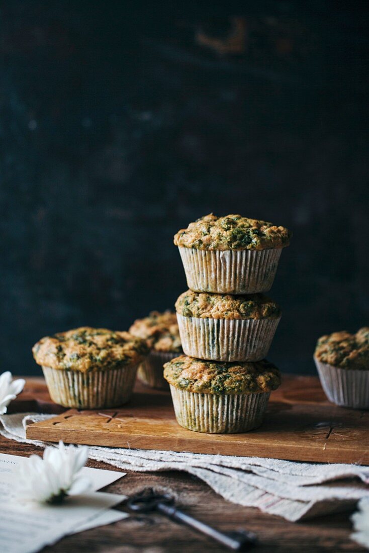 Stack of savoury chard muffins on a wooden board