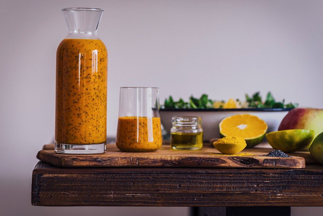 Turmeric Orange Poppy Seed Dressing in a bottle and a glass