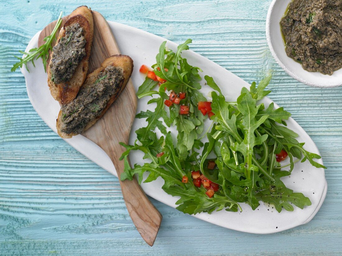 Rocket salad with olive crostini and pepper vinaigrette