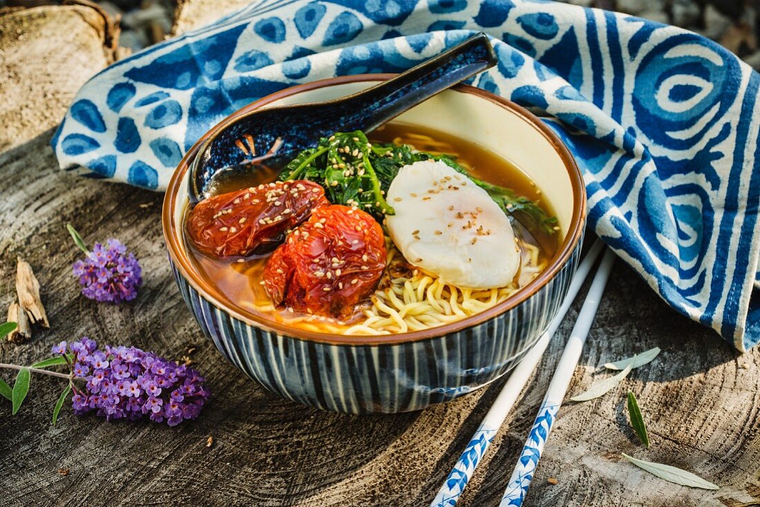 Japanese ramen soup with slow-roasted tomatoes and spinach