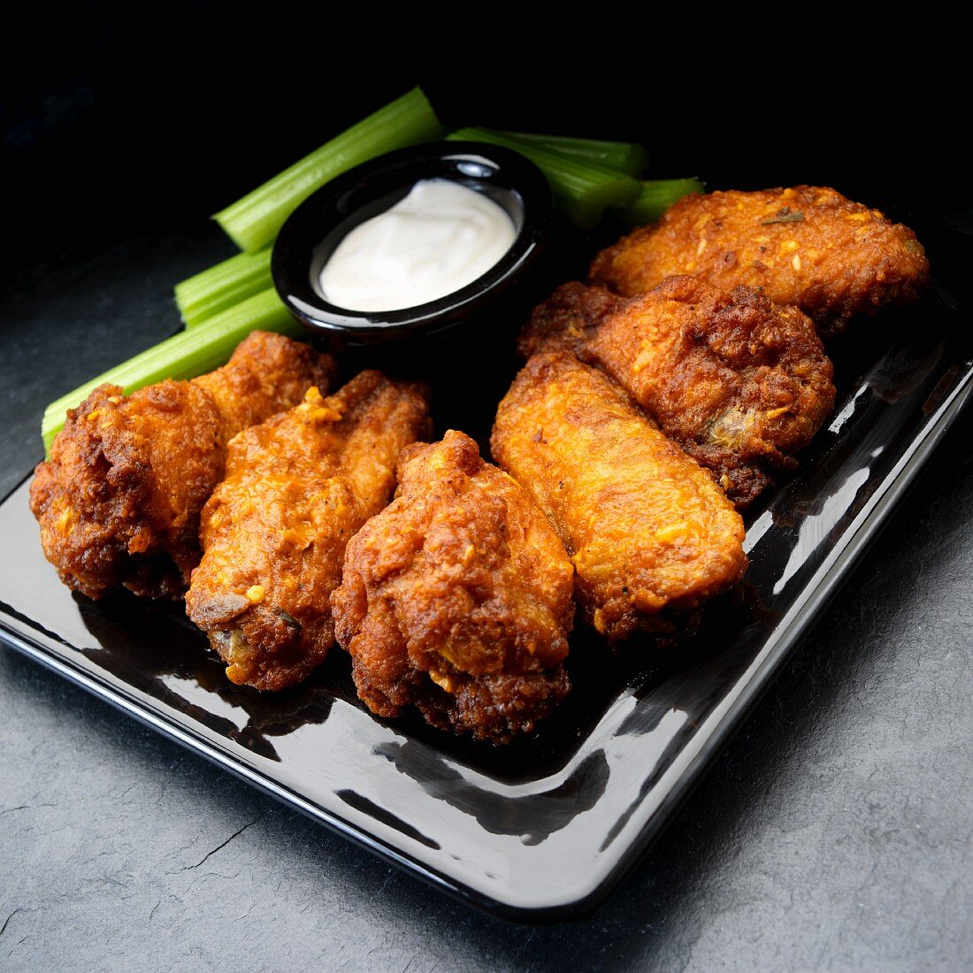 Buffalo chicken wings with garlic, celery and ranch dressing