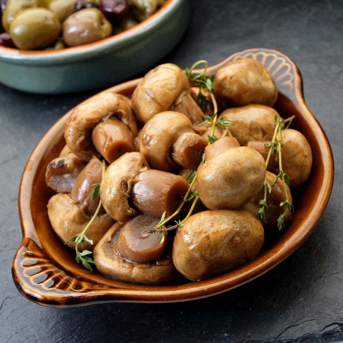 Marinated mushrooms with thyme as tapas in a dish (Spain)
