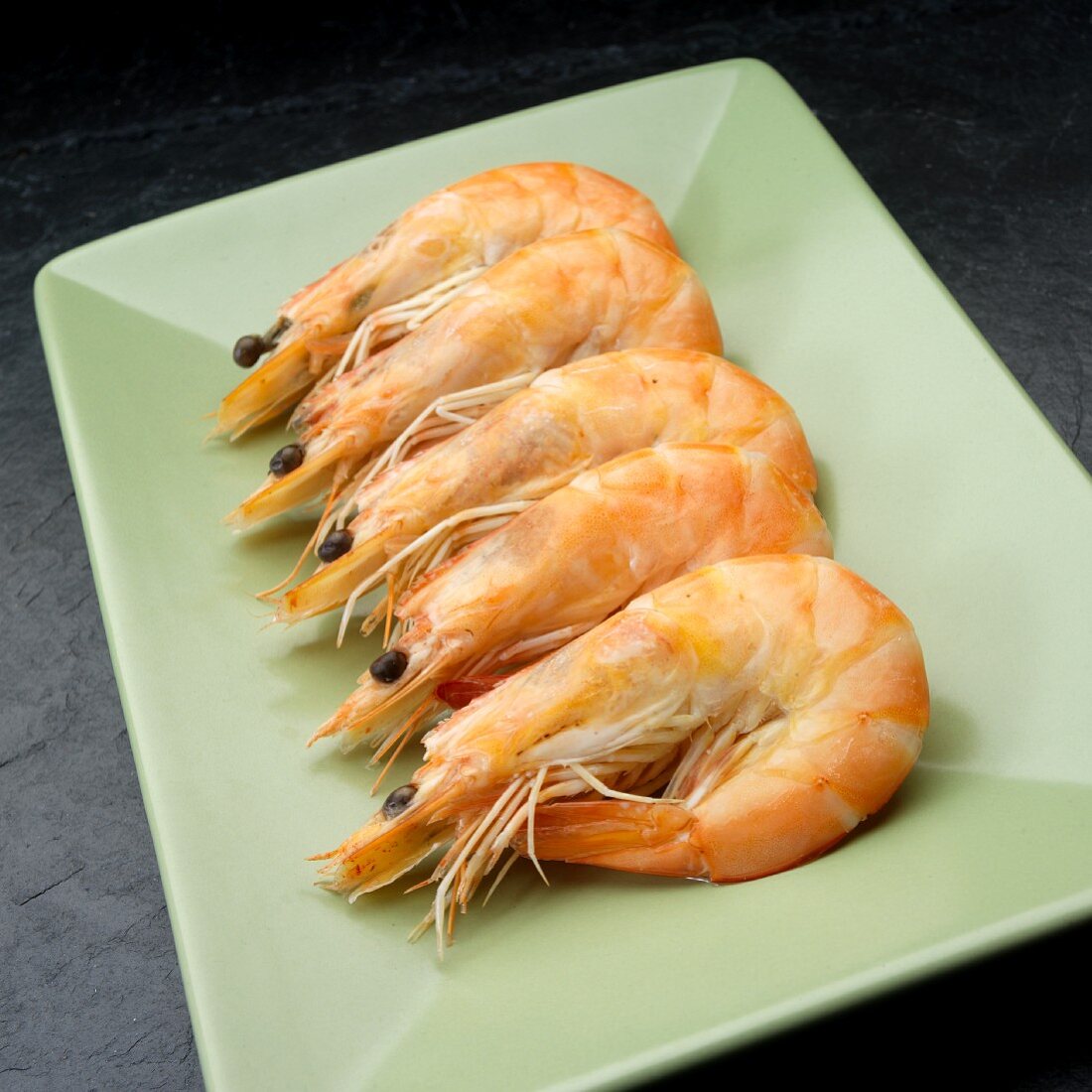 Five boiled prawns on a serving dish