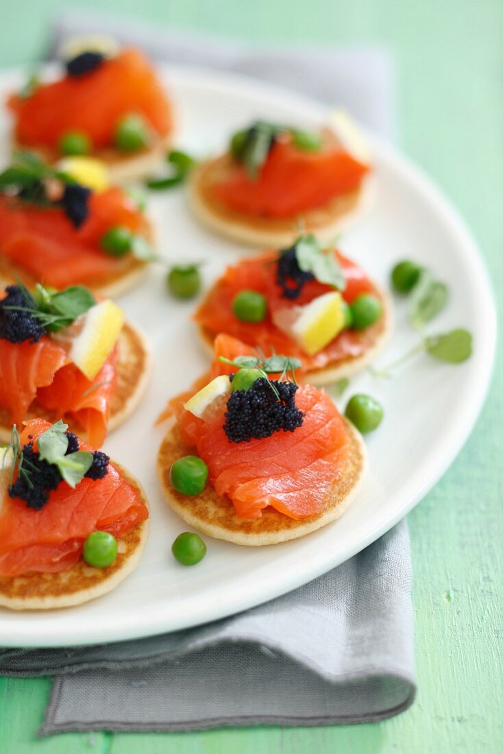 Blinis with smoked salmon, caviar and green peas