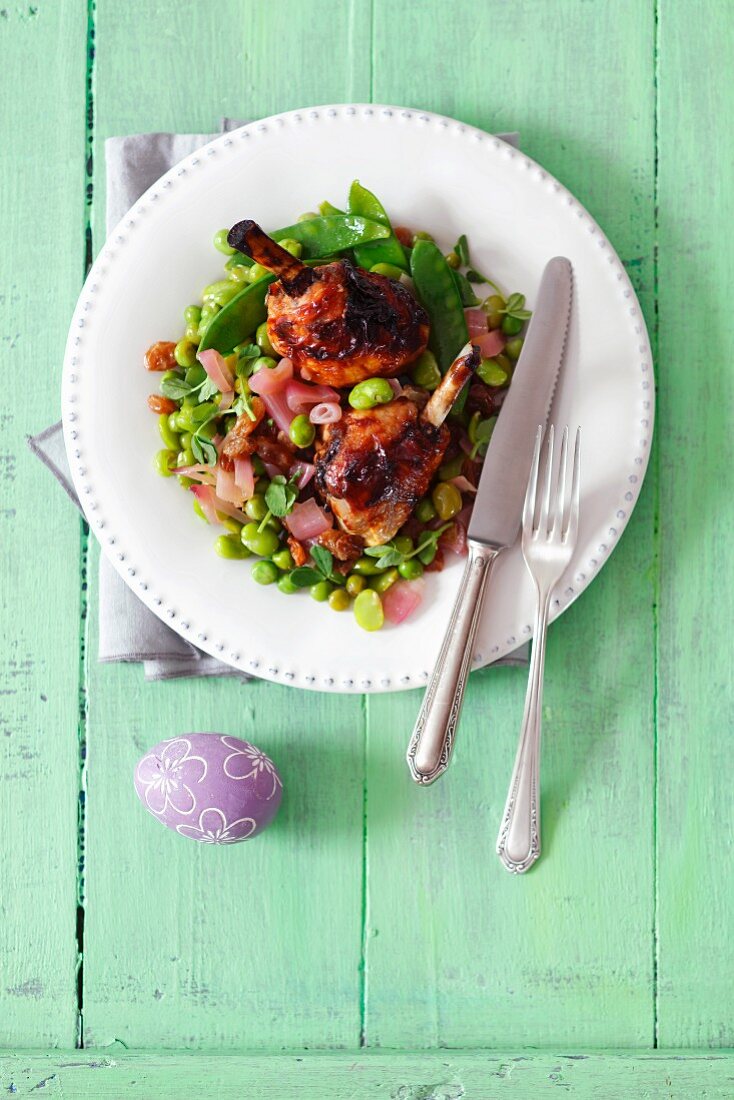 Chicken thighs with shallots, broad beans, green peas, mangetout and raisins for Easter