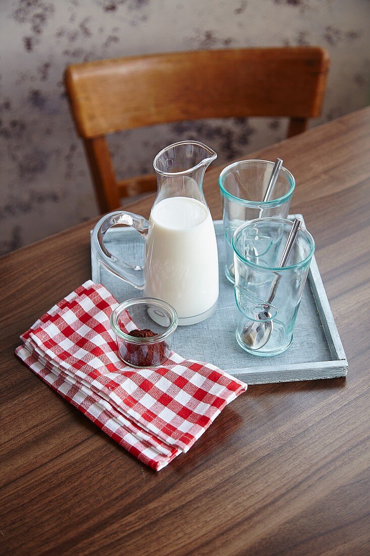 Ingredients for hot chocolate: milk, hot chocolate and glasses