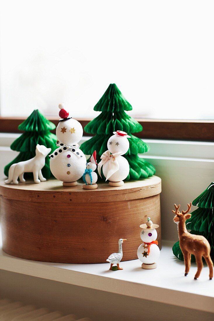 Winter arrangement of snowmen and fir tree ornaments