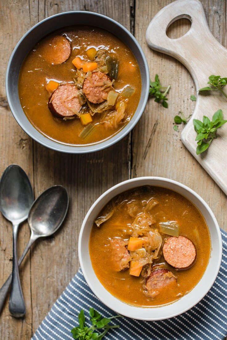 Flavoursome sauerkraut cabbage soup with smoked sausage (seen from above)