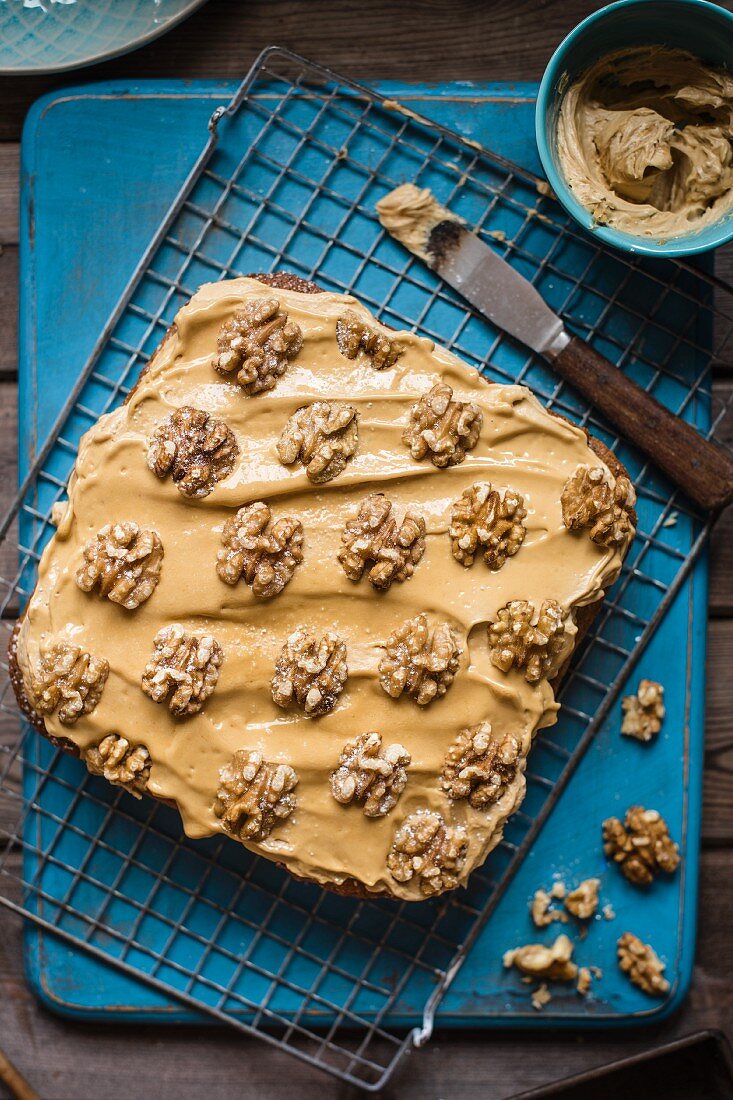 Coffee & walnut traybake with coffee icing on a cooling rack (seen from above)