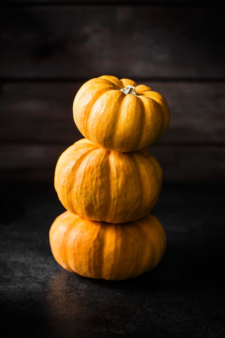 A stack of three little pumpkins