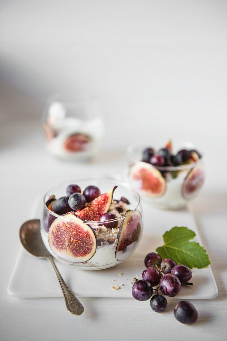 Fresh figs with Greek yoghurt, grapes and muesli for breakfast