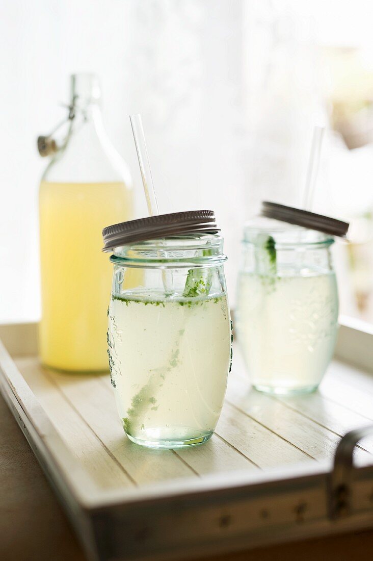 Lemonade in screw-top jars with straws