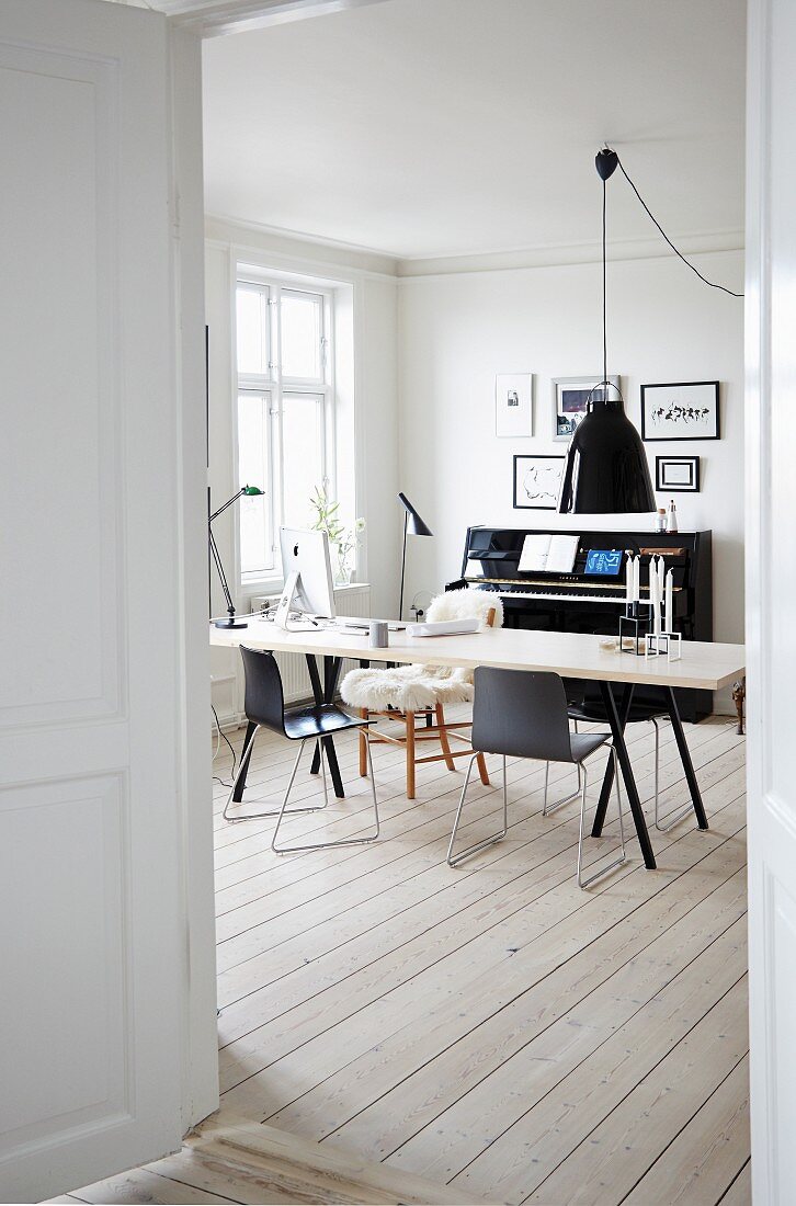 Piano and wooden floor in Scandinavian-style dining room