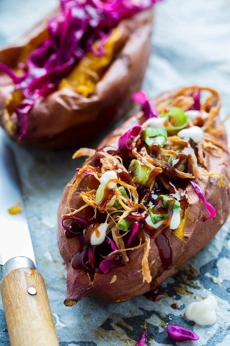 Baked sweet potatoes filled with pulled pork, coleslaw and steak sauce