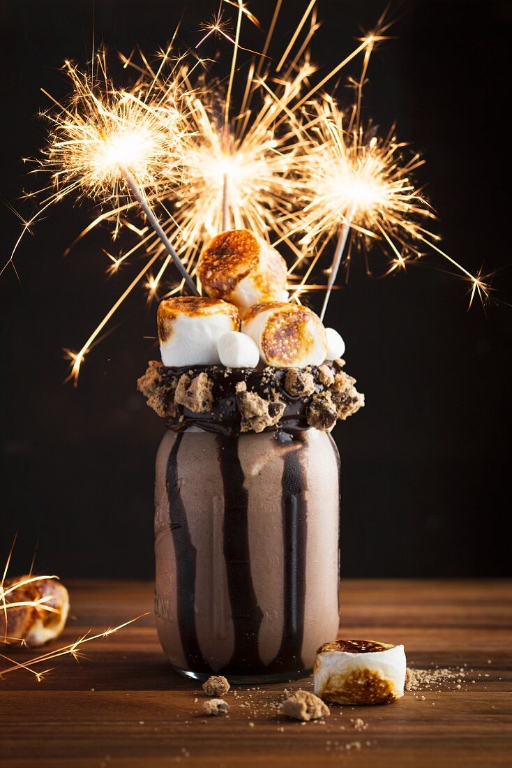 A chocolate freak shake with marshmallows and sparklers