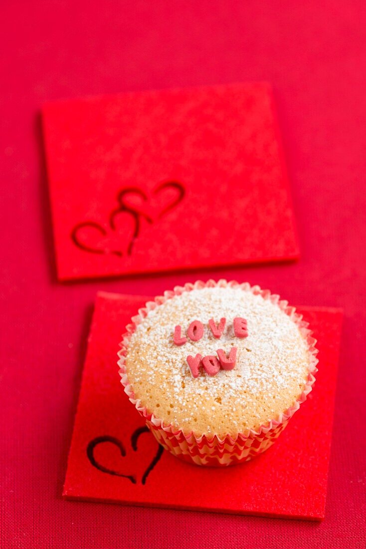 A cupcake with sugar letters spelling out 'LOVE YOU'