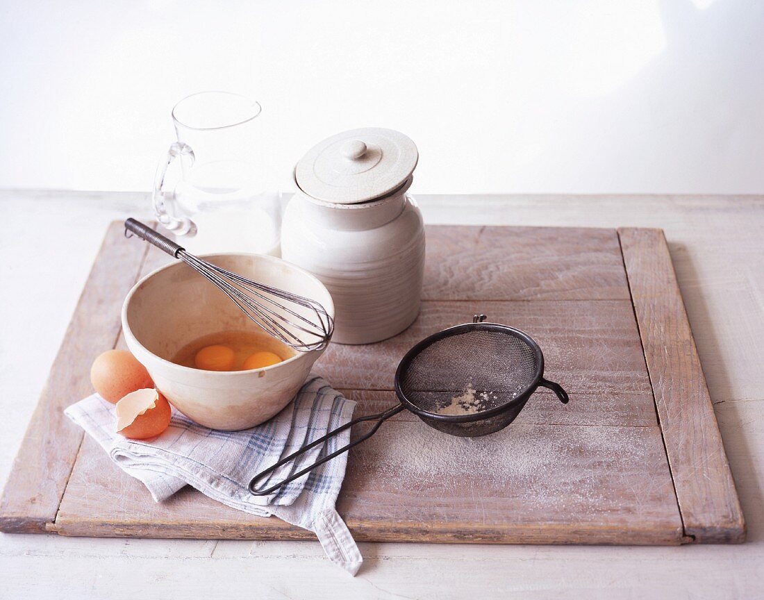 Whisked eggs and assorted baking utensils