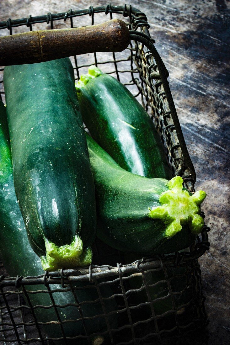Several courgettes in a wire basket
