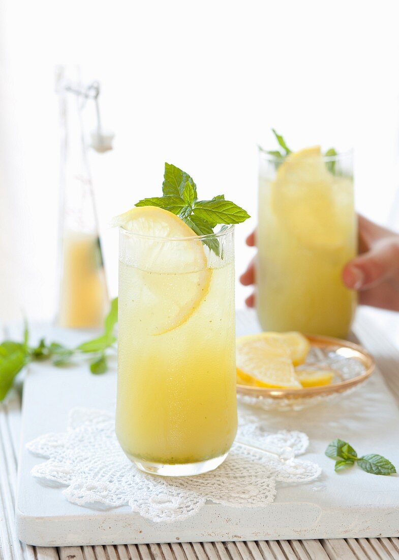 Apple and lemon juice with mint in glasses
