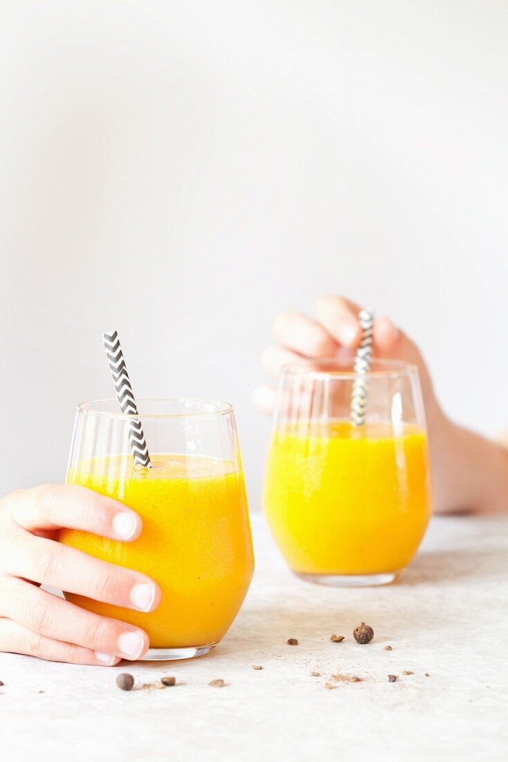 Mango and pineapple smoothies with turmeric