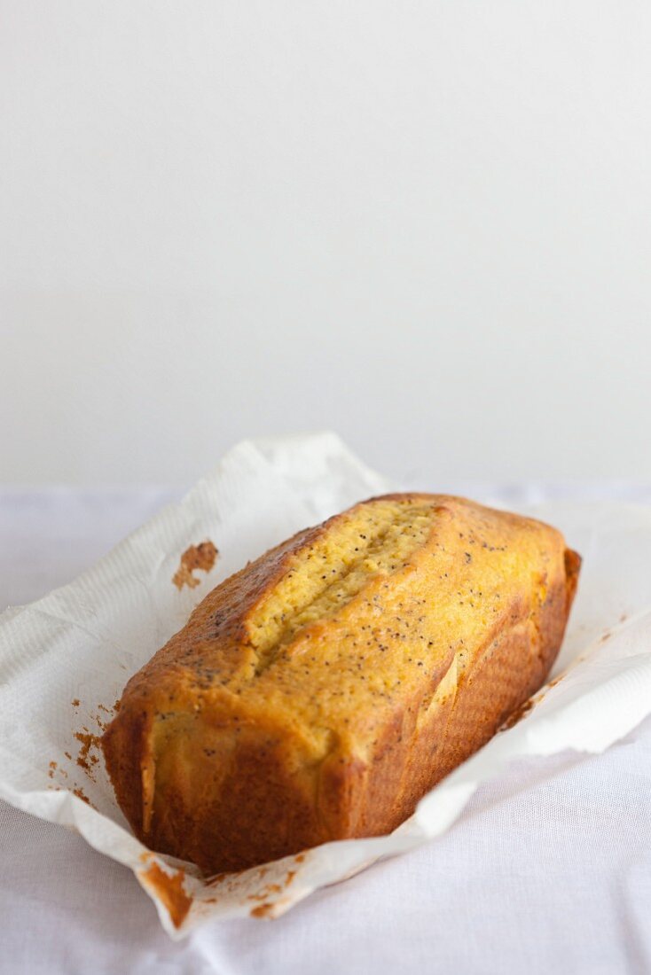 An orange and poppy seed loaf on baking paper