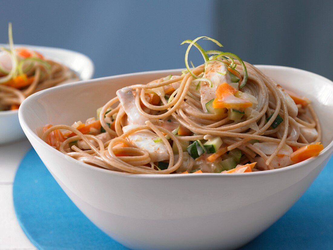 Spaghetti with fish, vegetables and coconut sauce
