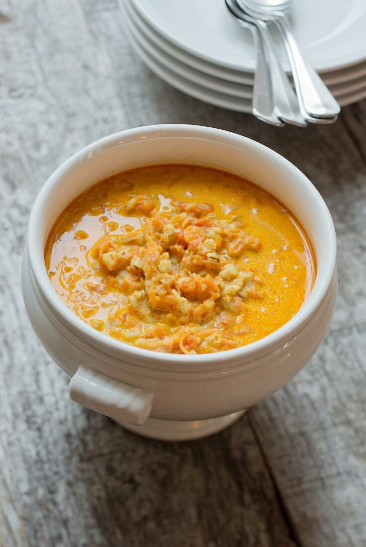 Carrot soup with barley in a soup tureen