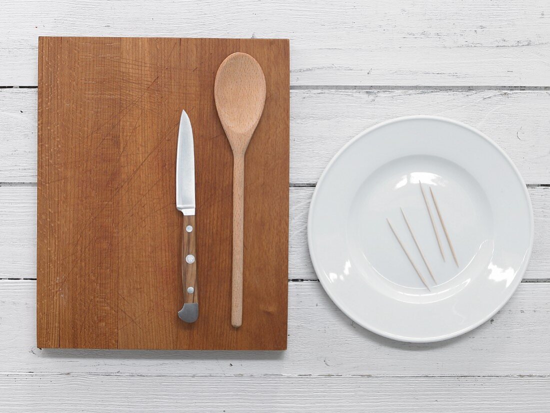 Plate, toothpicks, cooking spoon and knife