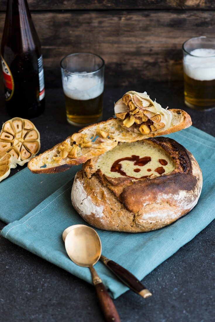 Beer and broccoli soup with Gruyere in a hollowed-out loaf of bread with oil and toasted garlic bread