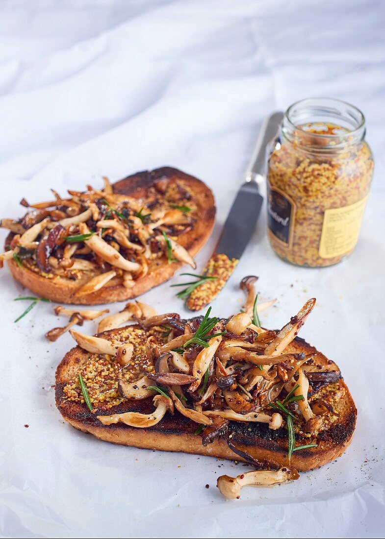 Forest mushrooms with garlic and mustard on toasted rye bread