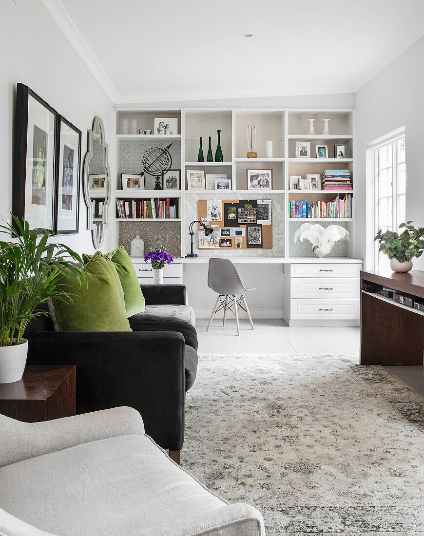 White shelving with integrated desk in living area