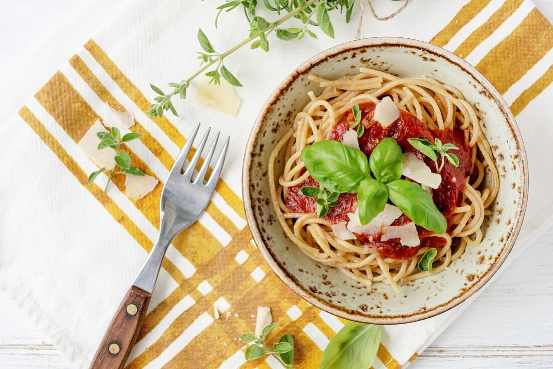 Plate of spaghettis with tomato sauce and basil