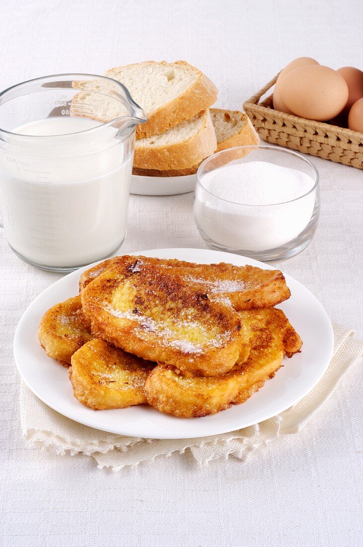 French toast on a plate in front of ingredients