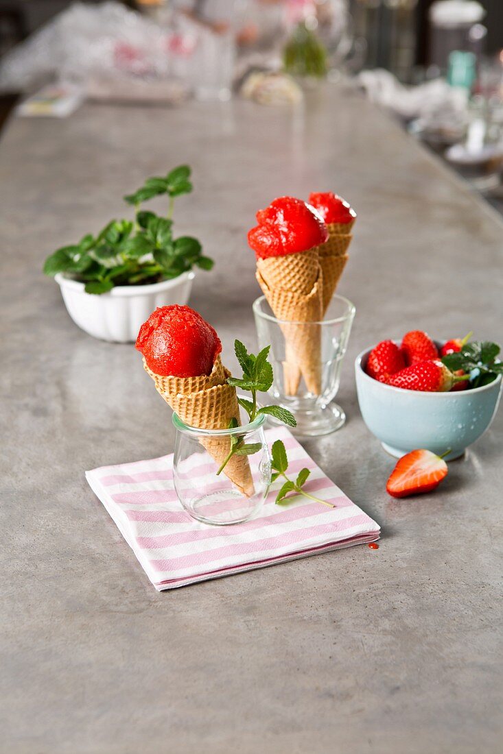 Strawberry sorbet with elderflower juice in wafer cones