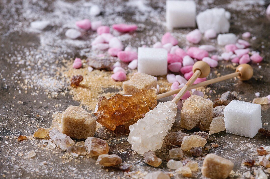 Variety of sugar white, brown pink fruit granulated, cubes and crystal