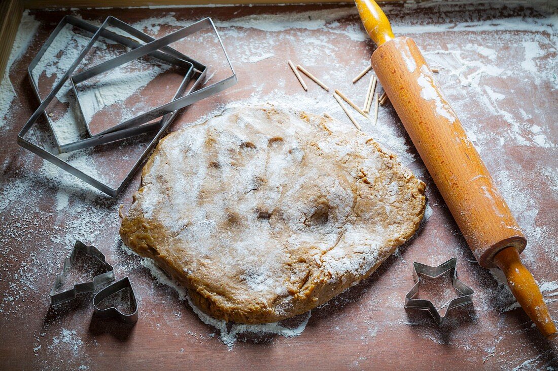 Doug for a gingerbread house with cutters and a rolling pin