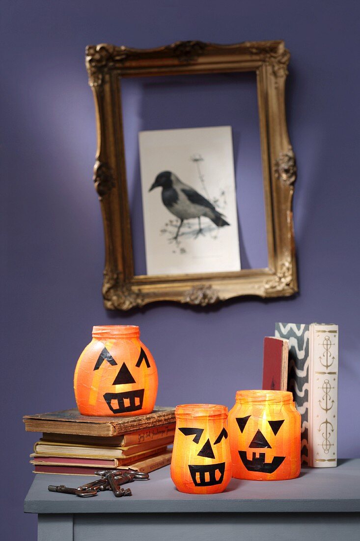 Halloween pumpkin lanterns made from old jam jars